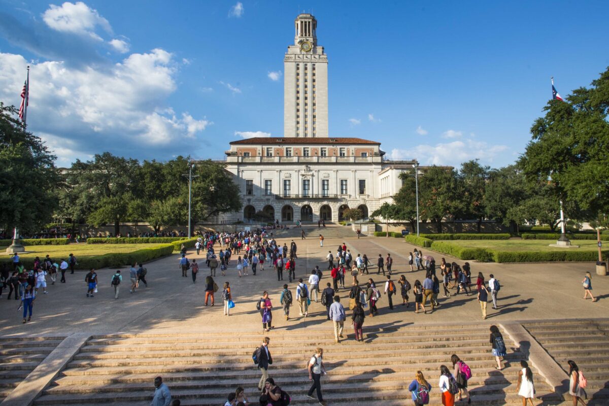 A bird's eye view of the UT tower with students walking in front